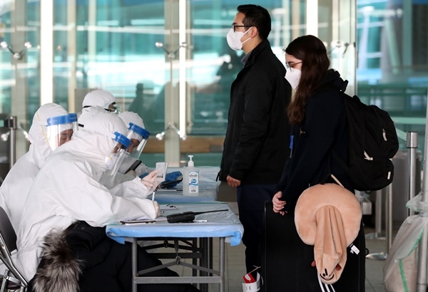 31일 오후 인천국제공항 제2터미널 옥외공간에 설치된 개방형 선별진료소(오픈 워킹스루)에서 런던 여객기를 타고 입국한 외국인들이 신종 코로나바이러스 감염증(코로나19)진단검사를 받기 위해 대기하고 있다.