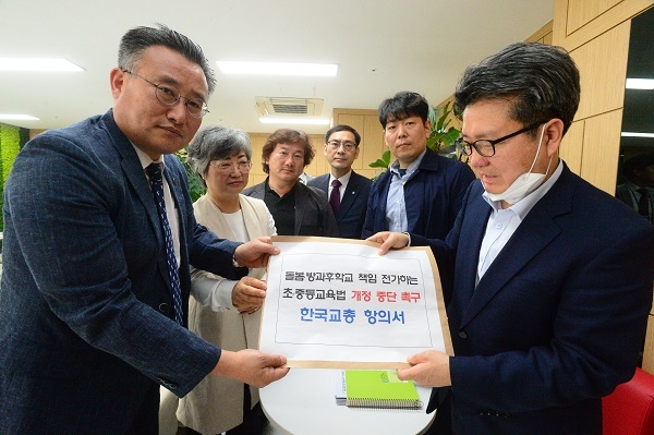 김갑철 한국교총 부회장(왼쪽)이 오석환 교육부 교육복지정책국장에게 항의서를 전달하고 있다.