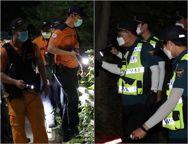 박원순 서울시장이 연락두절된 9일 저녁 북악산 일대에서 특수대응단 소방대원(왼쪽), 경찰 병력이 2차 야간 수색 작업을 하고 있다.